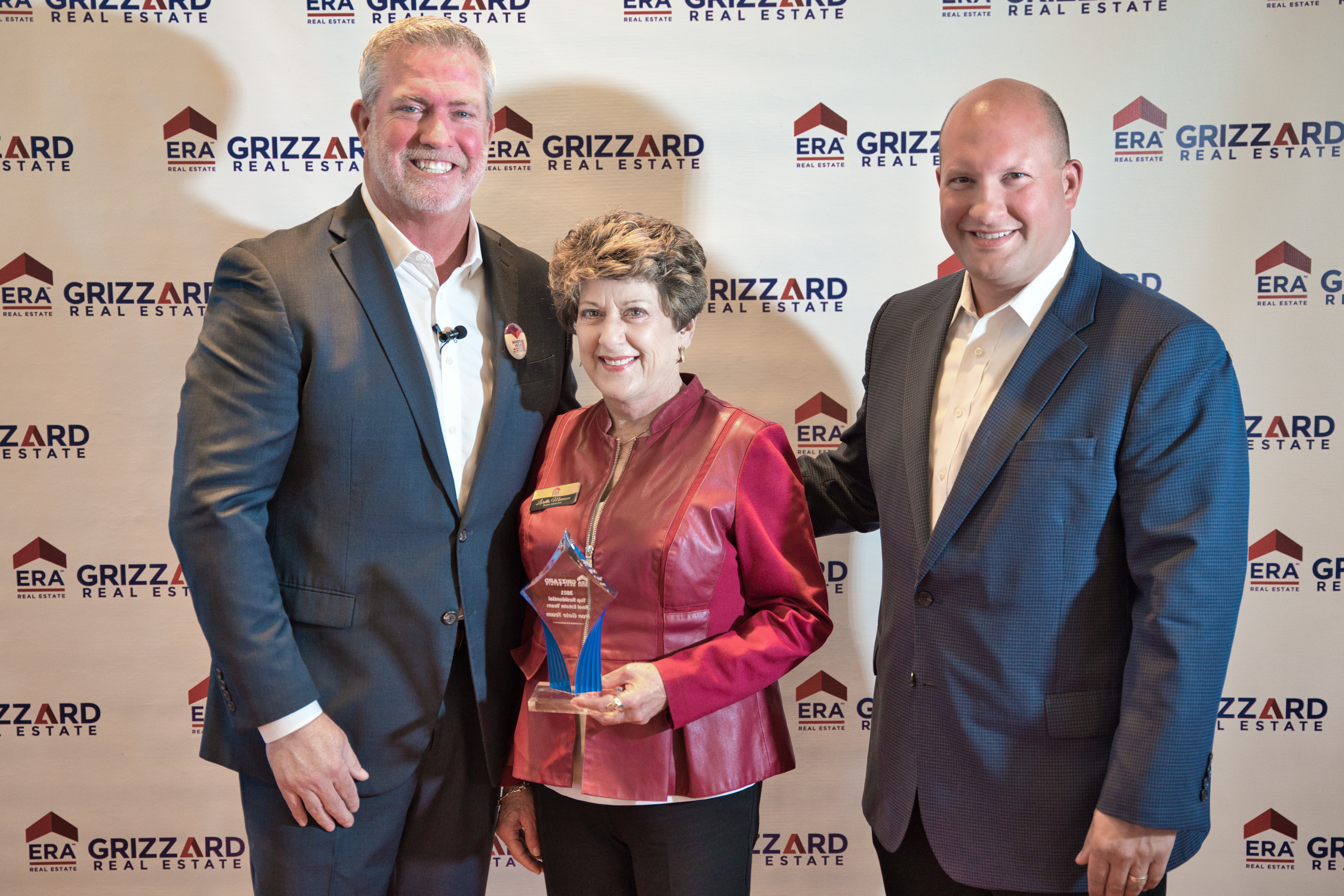 Gus, Loretta, Rich in front of backdrop